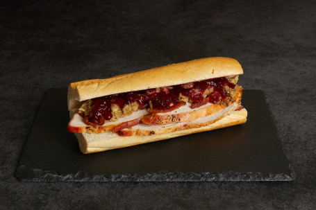 Freshly Carved Roast Turkey, Stuffing, Bacon Bits And Cranberry Sauce French Stick