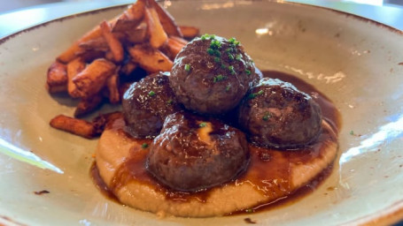 Meatballs Stuffed With Cheese And Accompanied By Its Demi-Glace, Aniseed-Infused Purée And Rustic Potatoes.
